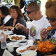 people sitting at a chili eating contest